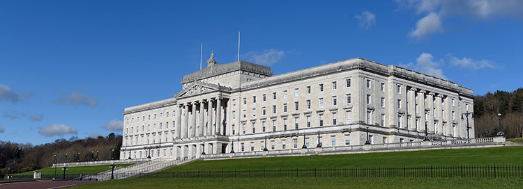 Parliament Buildings pictured against a blue sky.