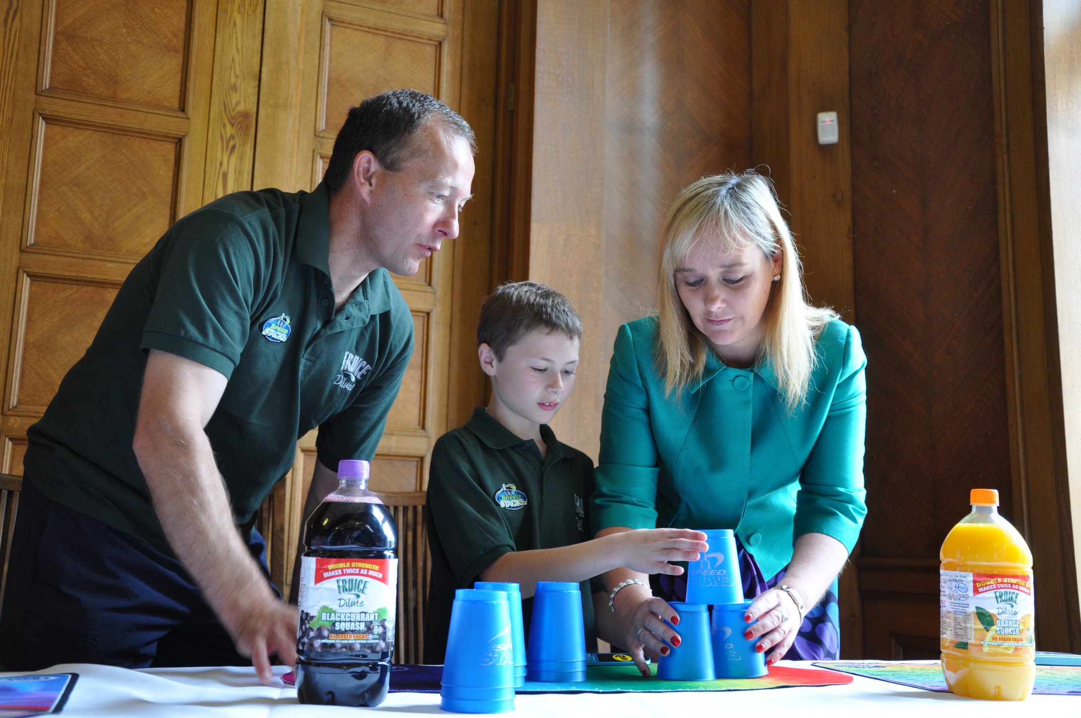 Coach of the Irish Sport Stacking Team, Micheal Nolan is pictured giving some tips on the sport to Michelle McIlveen MLA, Chairperson of the Culture, Arts and Leisure Committee.