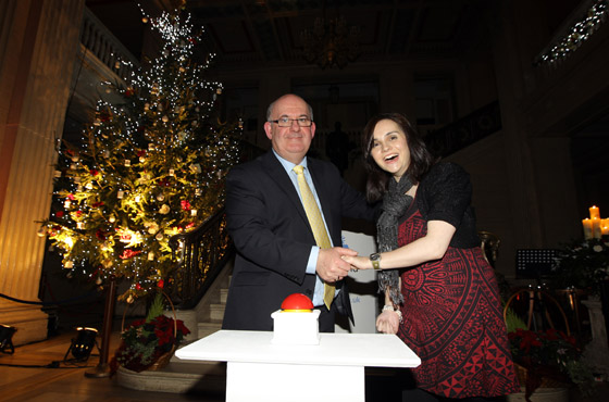 The Speaker of the Northern Ireland Assembly William Hay MLA, turns on the Christmas tree lights with the help of Cara McGerrigan.