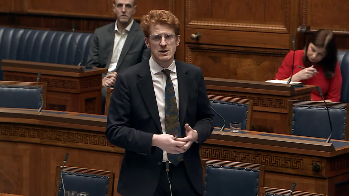 image shows the Leader of the Opposition, Matthew O’Toole MLA moving a motion in the Assembly Chamber.