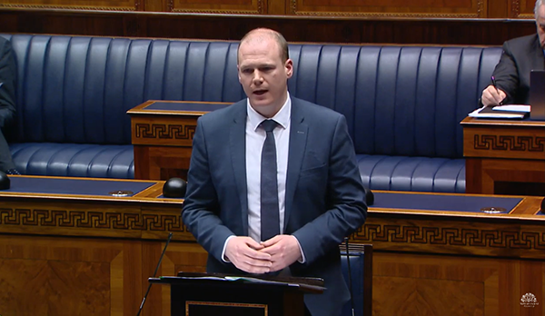 Minister Lyons speaking to the Assembly in February | Source: NI Assembly TV