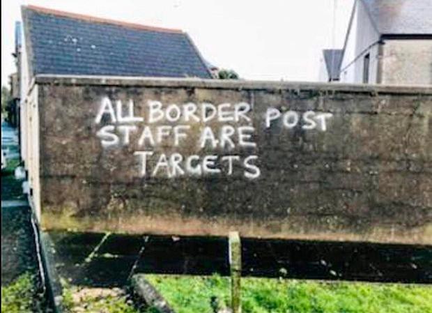  This picture shows a wall with the following graffiti - All border post staff are targets