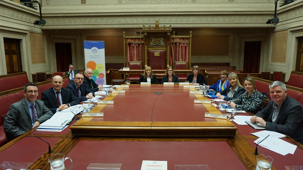 The Committee for Infrastructure pose for a photo before a Committee meeting.