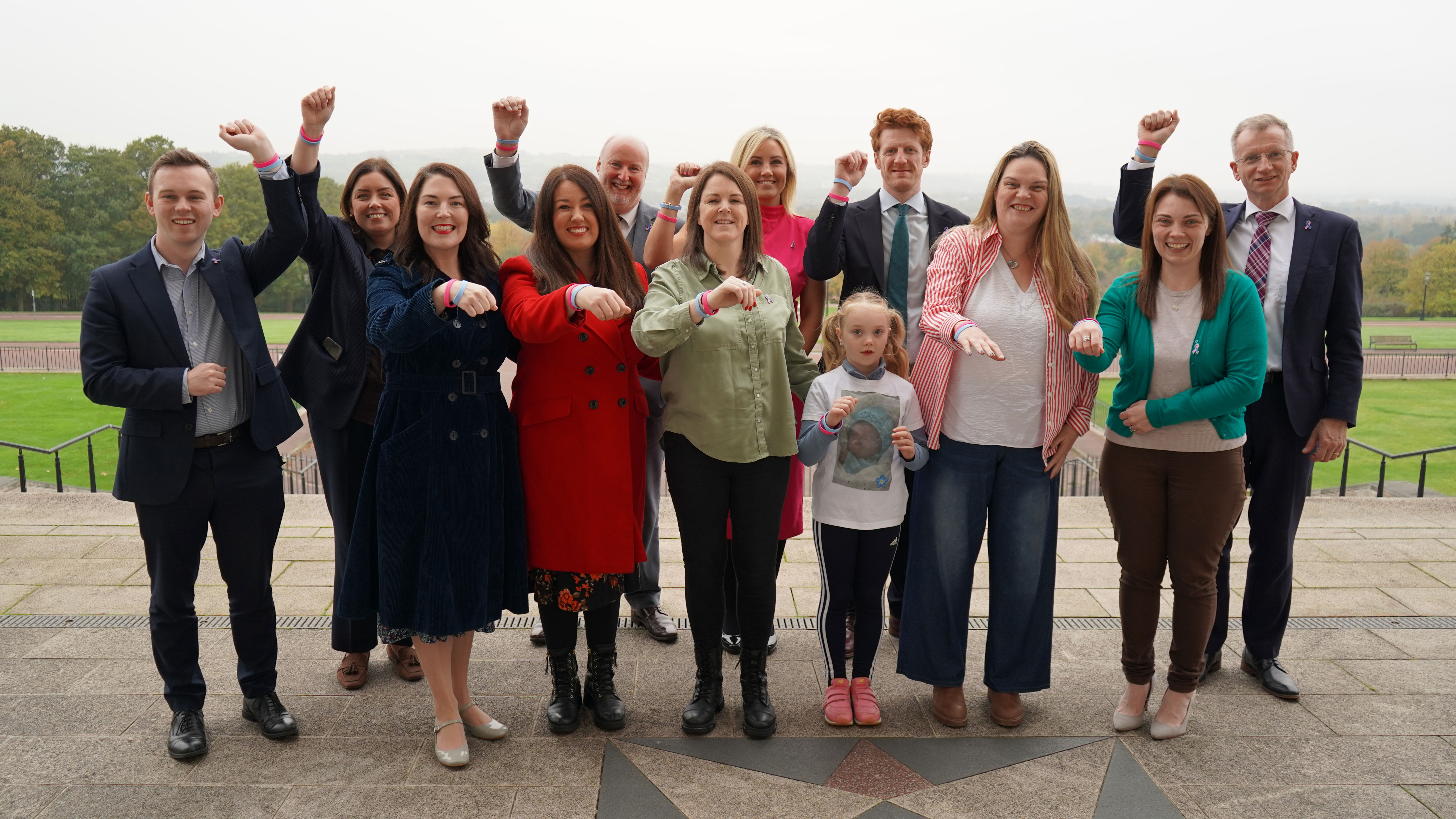 The Northern Ireland Assembly Finance Committee pictured with families, charities, and communities across Northern Ireland in marking Baby Loss Awareness Week 2025