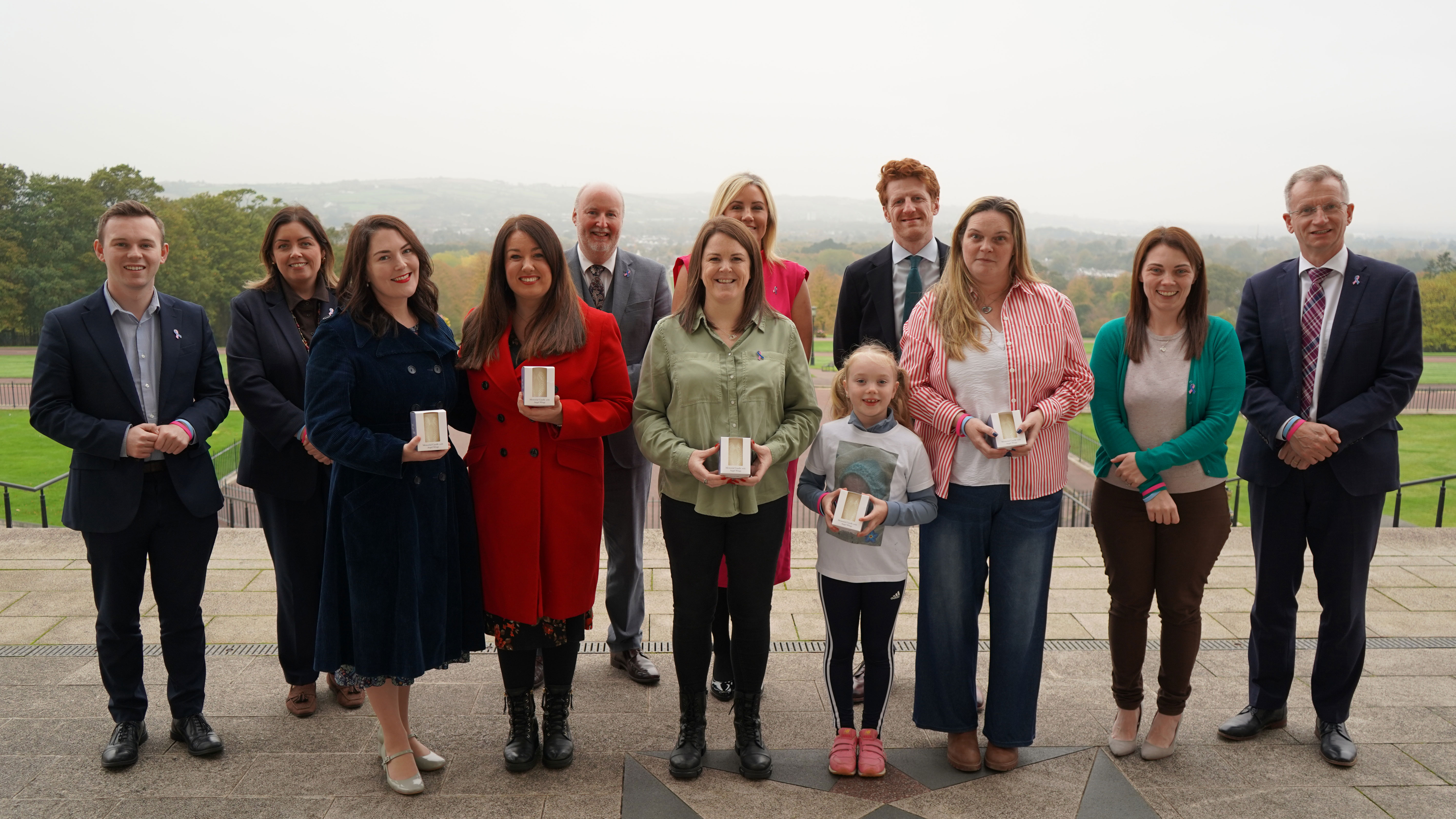 The Northern Ireland Assembly Finance Committee pictured with families, charities, and communities across Northern Ireland in marking Baby Loss Awareness Week 2025