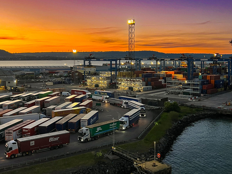 image shows haulage lorries at Belfast Port - the photograph is taken at dusk.