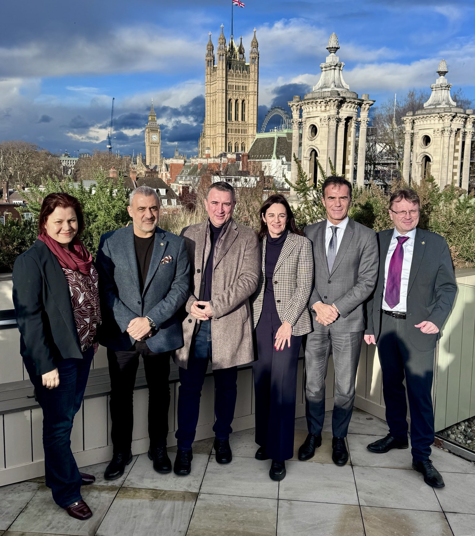 image shows the EU Parliament's Culture and Education Committee pictured in London with buildings in the background.