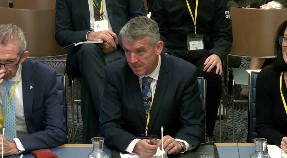 image shows representatives from the Atlantic Technological University (ATU) sitting in a committee room in Parliament Buildings providing evidence to the Economy Committee