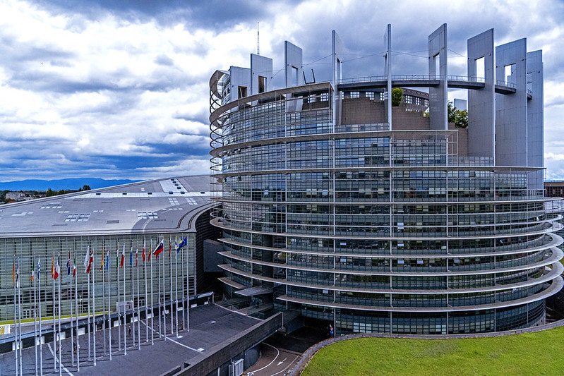 image shows the glass front of the European Parliament