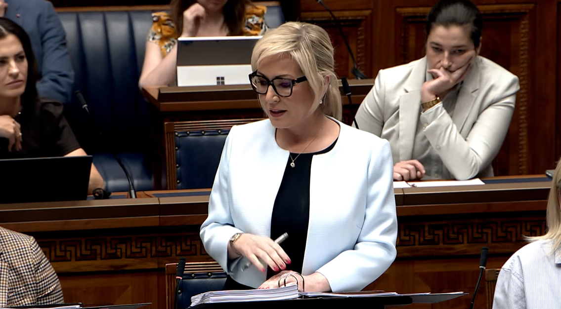 image shows the First Minister in the Assembly Chamber responding to questions from Members during Assembly question time. 