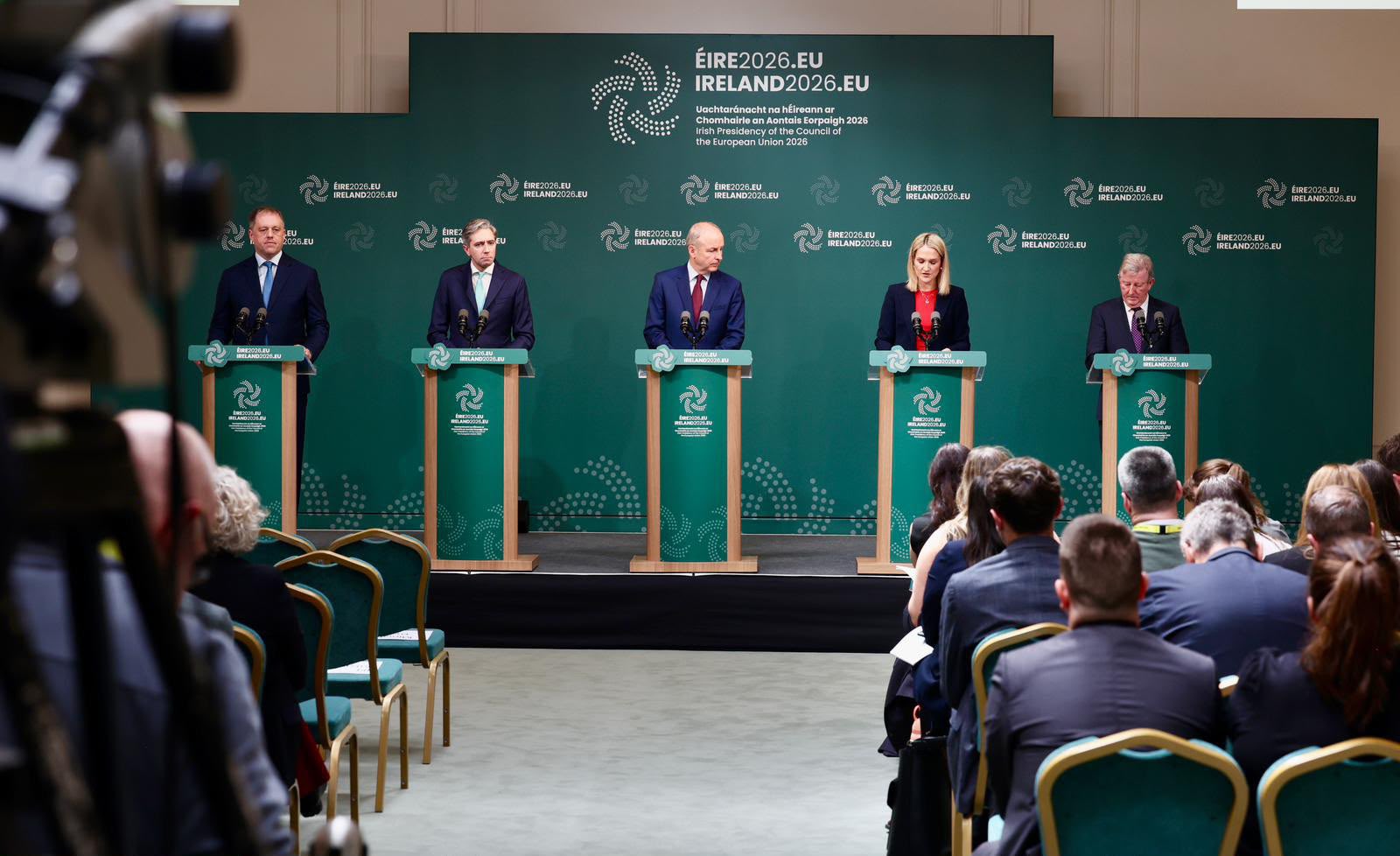 Image shows Taoiseach Micheál Martin; the Tánaiste Simon Harris; the Minister for Foreign Affairs and Trade, Helen McEntee and; the Minister of State for European Affairs, Thomas Byrne standing at green lecterns with Taoiseach Micheál Martin; the Tánaiste Simon Harris; the Minister for Foreign Affairs and Trade, Helen McEntee and; the Minister of State for European Affairs, Thomas Byrne Taoiseach Micheál Martin; the Tánaiste Simon Harris; the Minister for Foreign Affairs and Trade, Helen McEntee and; the Minister of State for European Affairs, Thomas Byrne standing at green lecterns with Irish Presidency of the Council of the European Union on them