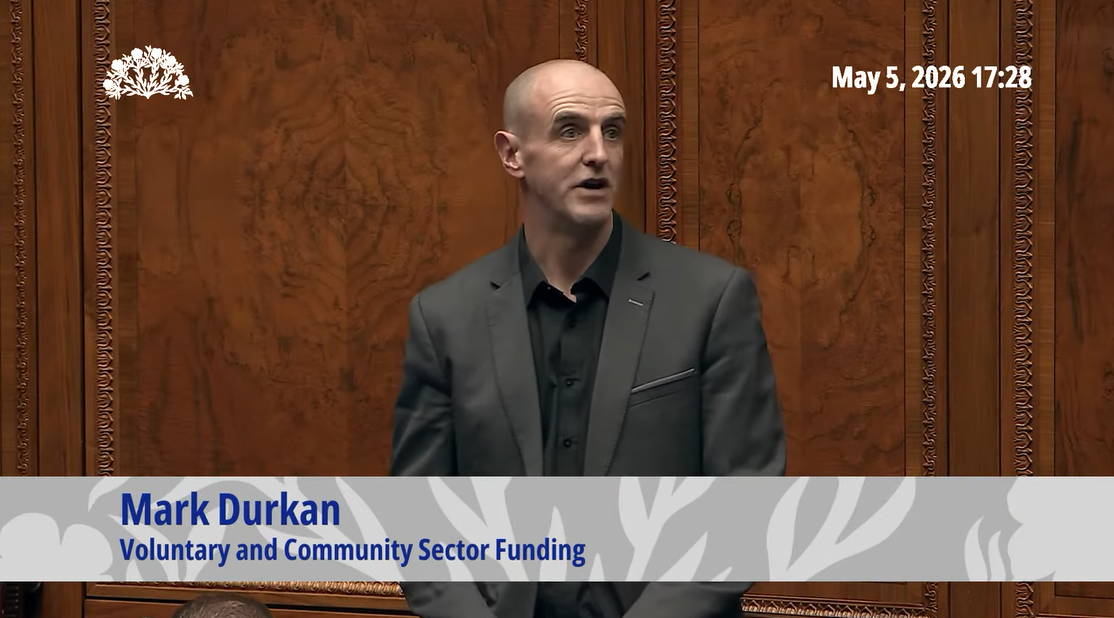 image shows Mark Durkan MLA taking part in a debate in the Assembly Chamber