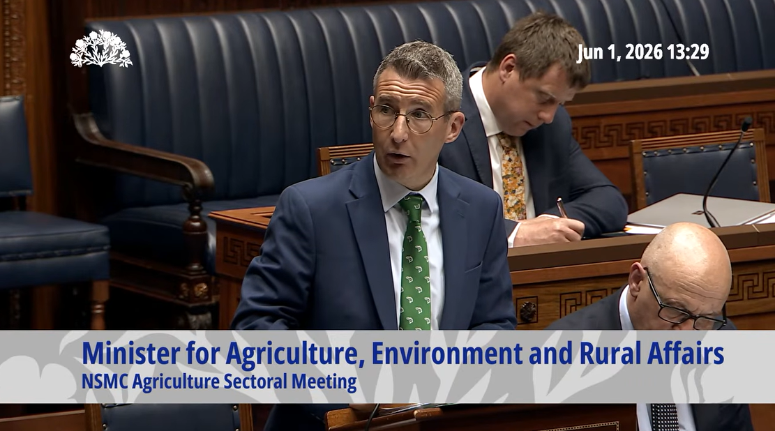 image is of The Minister of Agriculture, Environment and Rural Affairs, Andrew Muir MLA in the Assembly Chamber as he deNorth/South Ministerial Council (NSMC) in the aquaculture and marine sector and the NSMC agriculture meeting