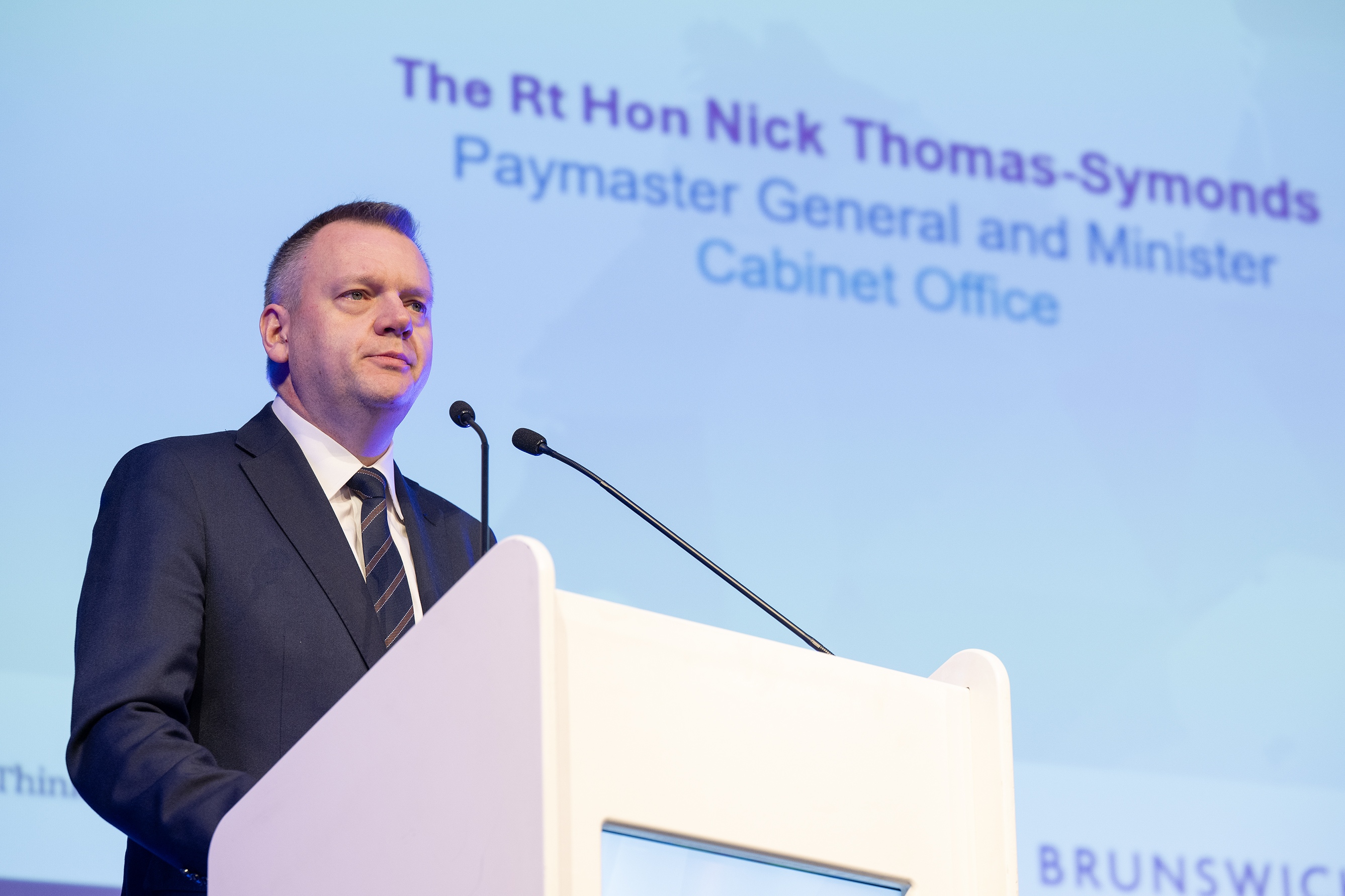 image is of the Minister for the Constitution and European Union Relations, Nick Thomas-Symonds MP at a podium speaking to delegates at the EU/UK Forum in Brussels. 