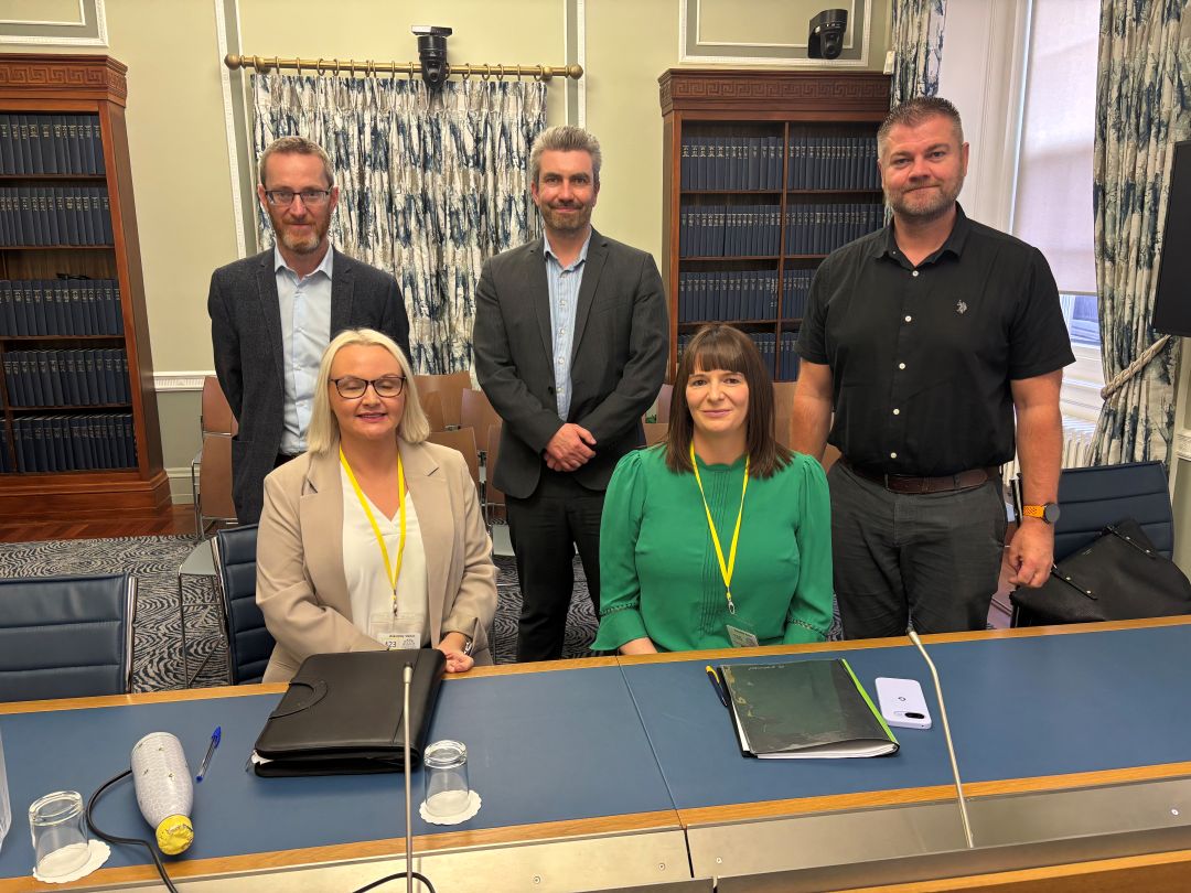 Standing are Members of the Committee for Health with representatives of Community Transport Association