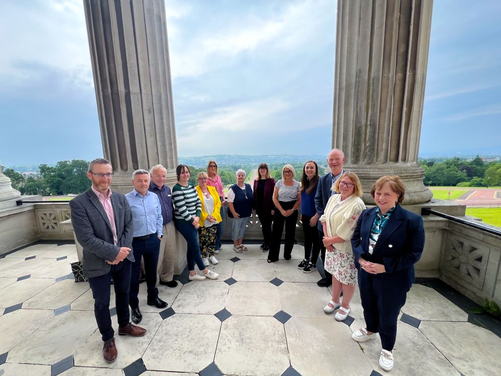 Members on the balcony at Parliament Buildings with participants of the Lived Experience Forum