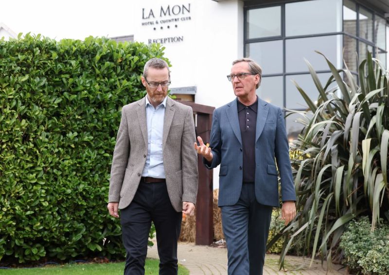 Walking outside La Mon Hotel is Philip McGuigan MLA and Rt Hon Alan Milburn