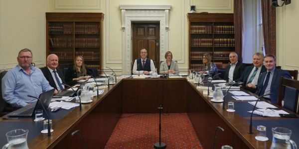 The Committee poses for a photo before the start of a meeting.