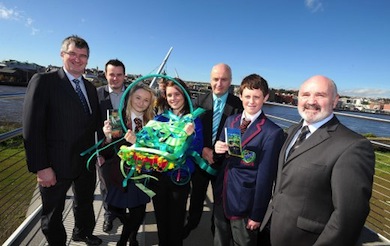 Chairperson of the Committee for the Office of the First Minister/deputy First Minister, Tom Elliott MLA (left) and Committee member Alex Maskey MLA (right) stand on the Peace Bridge over the River Foyle with young people and school representatives taking part in a local art and education initiative on Rivers of the World organised by the British Council and local partners Ilex