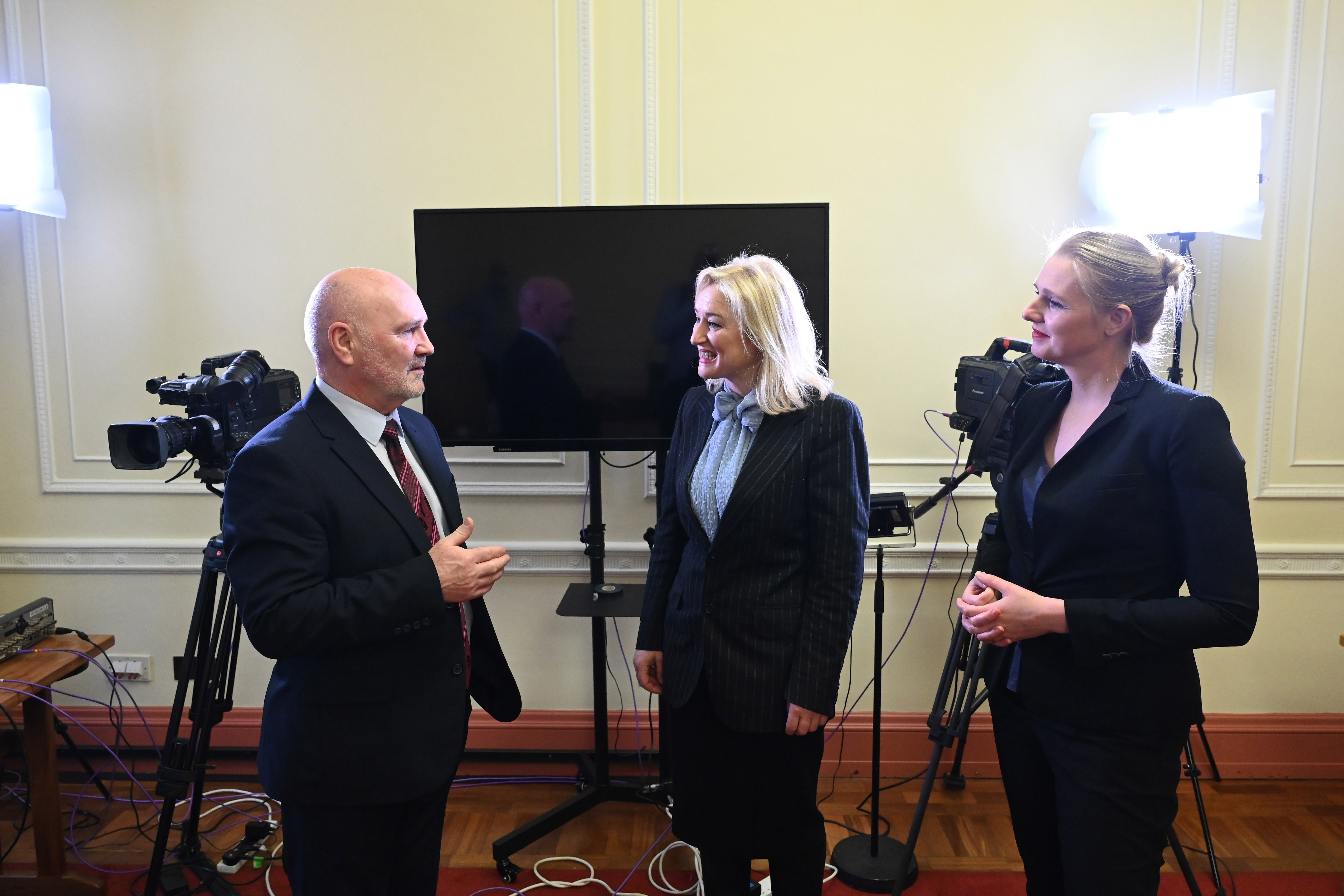 The Speaker of the Northern Ireland Assembly, Alex Maskey MLA pictured with (L-r:  Kristina Laverty (BSL Signer) and Amanda Coogan (ISL Signer).