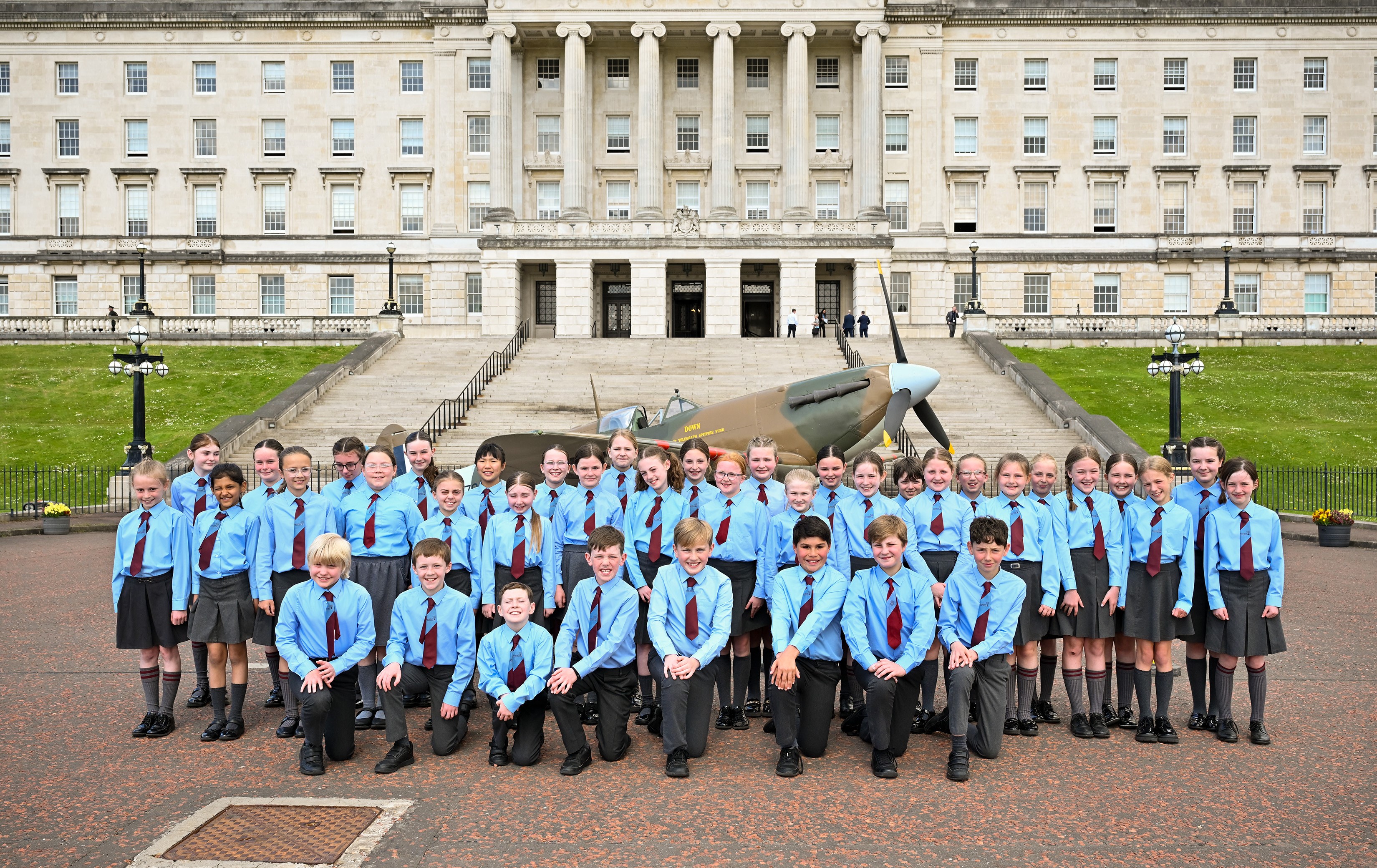 Pupils from Pond Park Primary School with a Spitfire Mk2a replica aircraft at the Northern Ireland Assembly’s VE Day Event on Tuesday 6th June 2025. As part of the event pupils sang a selection of wartime songs.