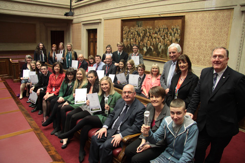 The Speaker of the Northern Ireland Assembly, Mr William Hay MLA, awarded prizes to winners of an Assembly competition to mark the 100th anniversary of women’s suffrage.  Pictured with the Speaker (front row, third from right) are MLAs, teachers and competition winners