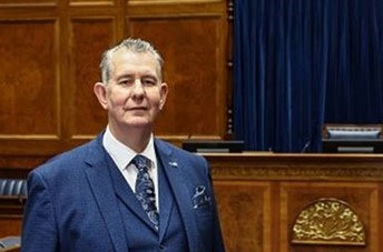 Assembly Speaker (and Chairperson of the Assembly Commission) Edwin Poots poses in front of the top table in the Assembly Chamber, Parliament Buildings. The top table is where the Speaker sits when he presides over Assembly Plenary sessions.